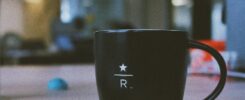 black ceramic mug on wooden table